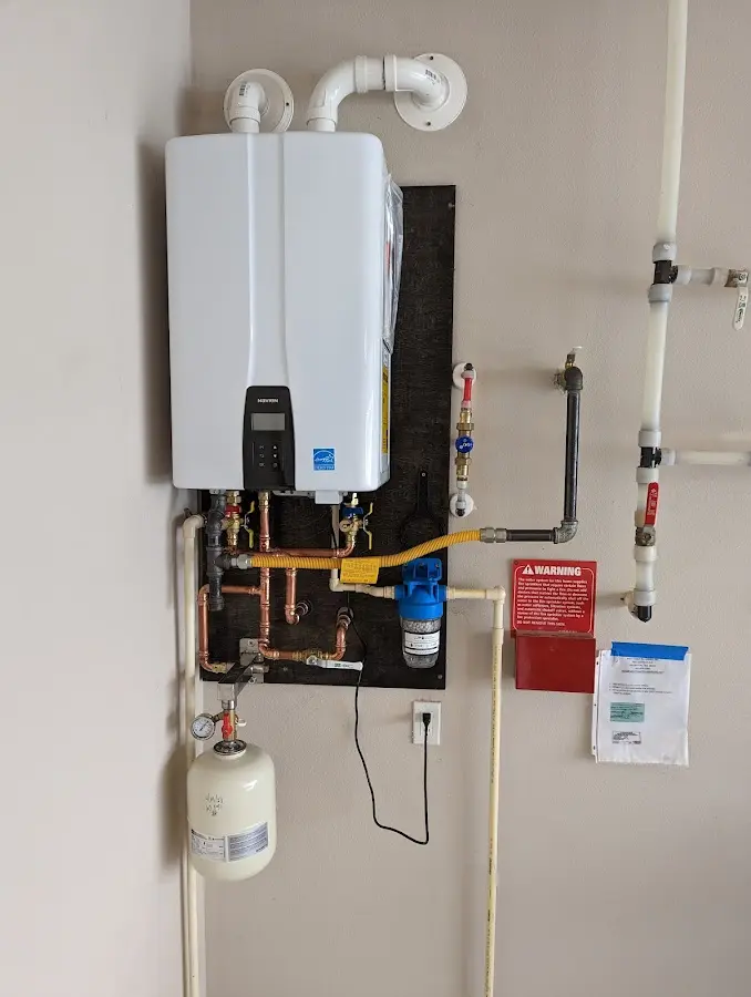 Professional plumber installing copper piping in a Medford home